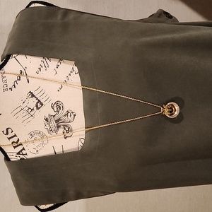 Gold necklace with green flower.